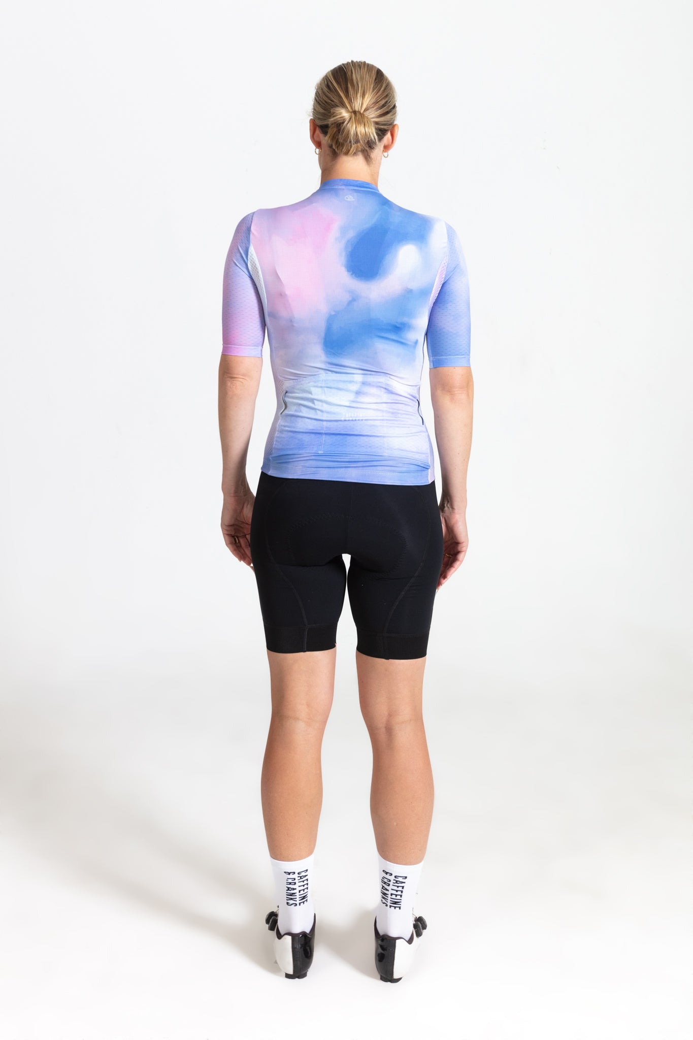 Back view of C&C Coral Jersey with pink, blue, & purple abstract print. Women's cycling top.