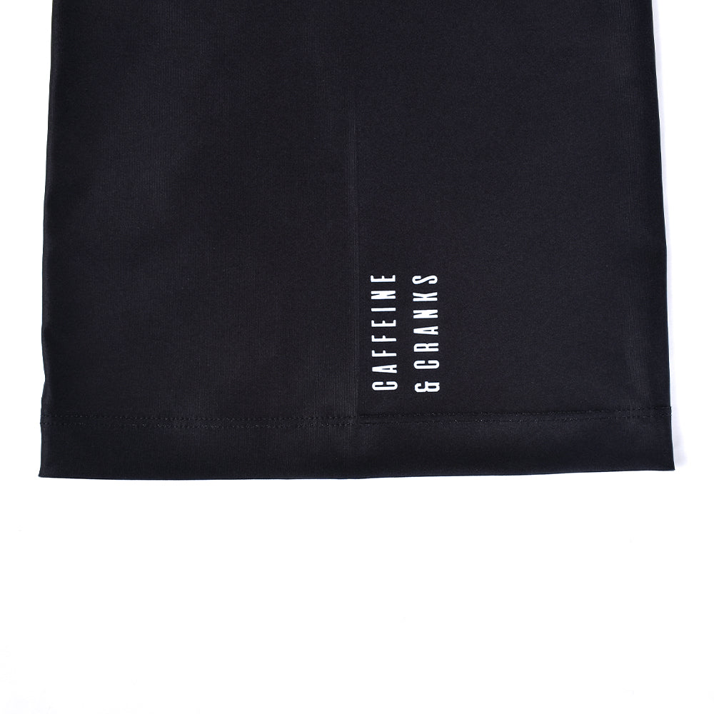 Black C&C Neck Warmer with white "CAFFEINE & CRANKS" logo, close-up detail.