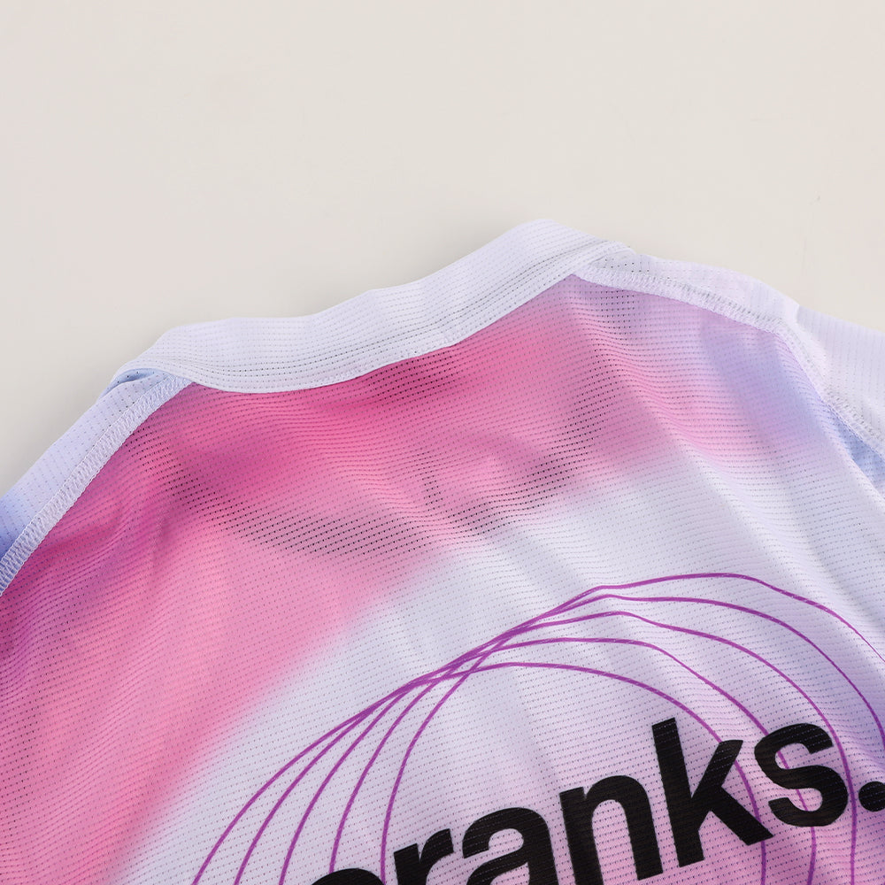 Close-up view of the collar and shoulder of the C&C Drift Jersey, featuring pink & purple gradient and text.