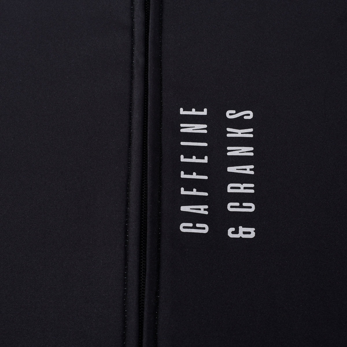 Close-up of a black men's Core Thermal Jersey with "CAFFEINE & CRANKS" logo.