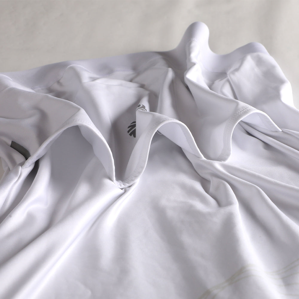 Close-up of white men's Pinnacle Thermal Jersey, showing draped fabric and subtle grey logo.