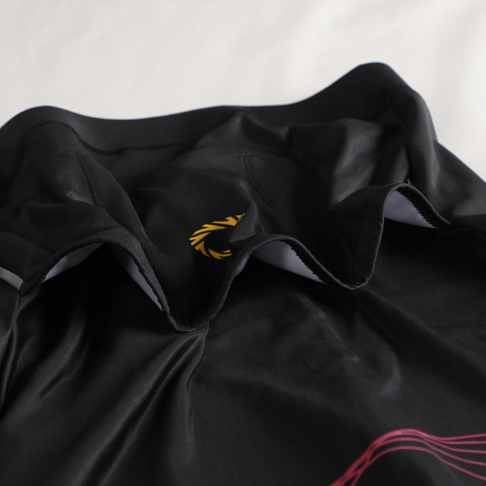 Close-up of a black women's thermal jersey with yellow logo.