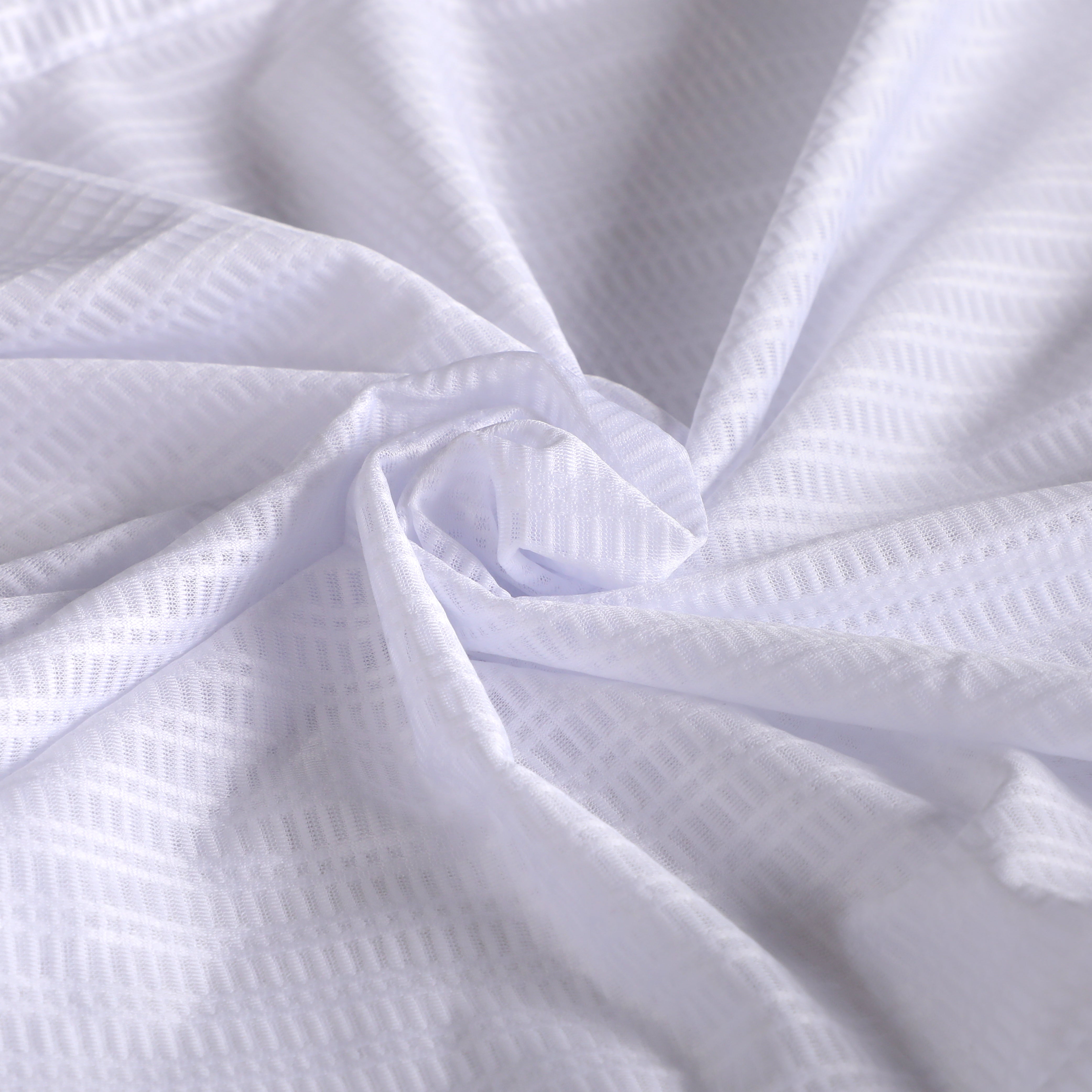 Close-up of white C&C Core Baselayer fabric with a subtle diamond weave pattern.