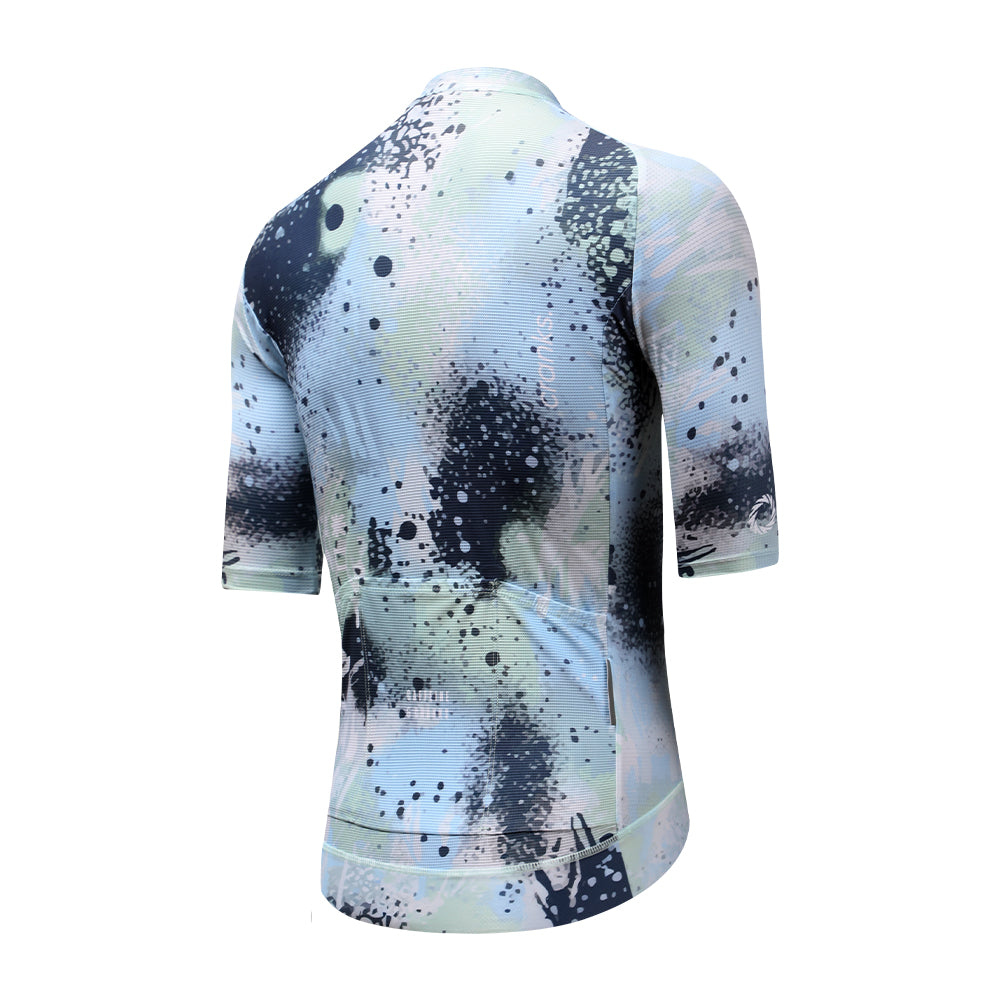 View of the back of a women's cycling jersey with a blue & mint abstract overspray pattern.