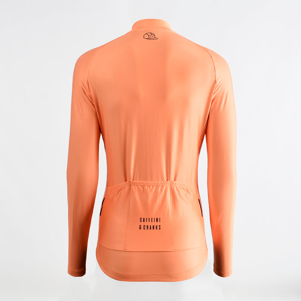 Back view of orange women's Core Thermal Jersey with black logo detail.