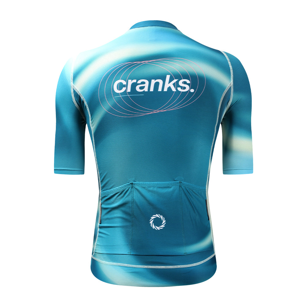 Back view of mens C&C Flux jersey - teal, pink logo, three pockets and abstract design.
