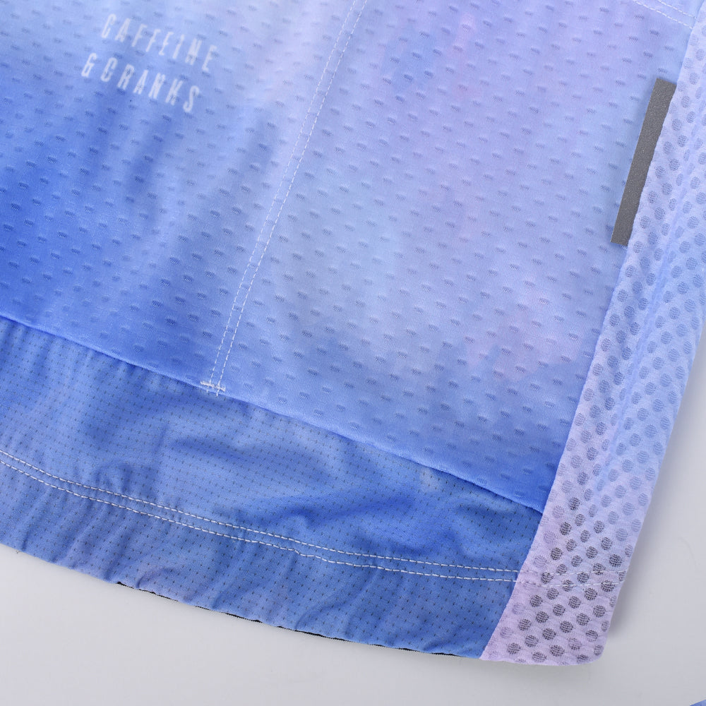 Close-up of men's C&C Coral Jersey. Blue & pink gradient, breathable mesh panels.