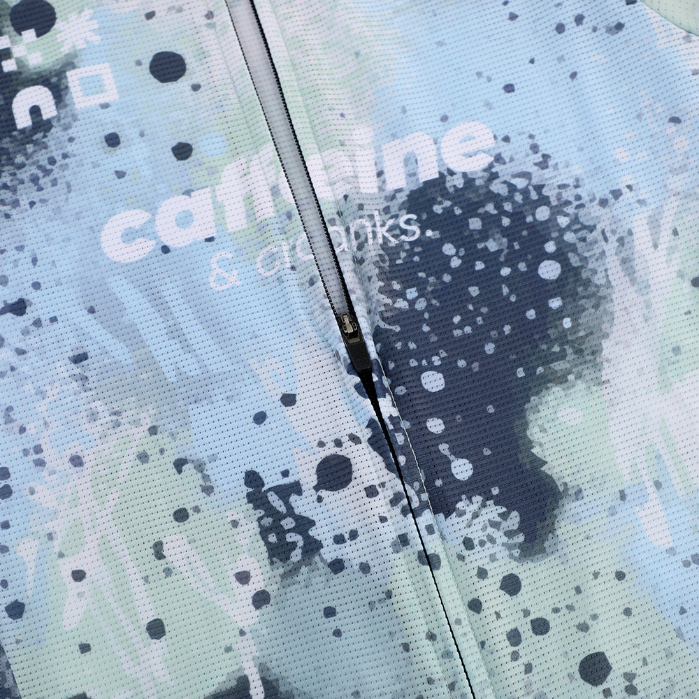 Close up of the C&C Overspray Jersey - Womens, showing a blue, green, & white splatter print with a full zip.