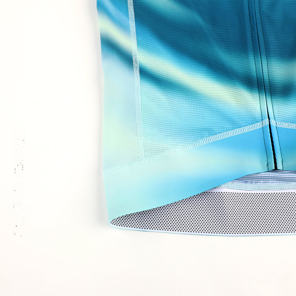 Right side view of C&C Flux Jersey, blue, green, and yellow gradient, zipper details. Grid hem.