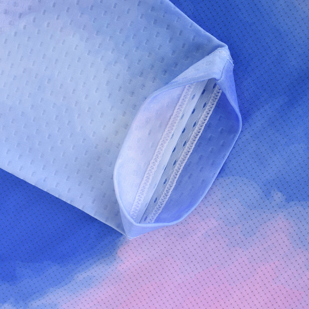 Close-up of C&C Coral Jersey sleeve opening showing blue, pink, and white gradient pattern with speckled texture.