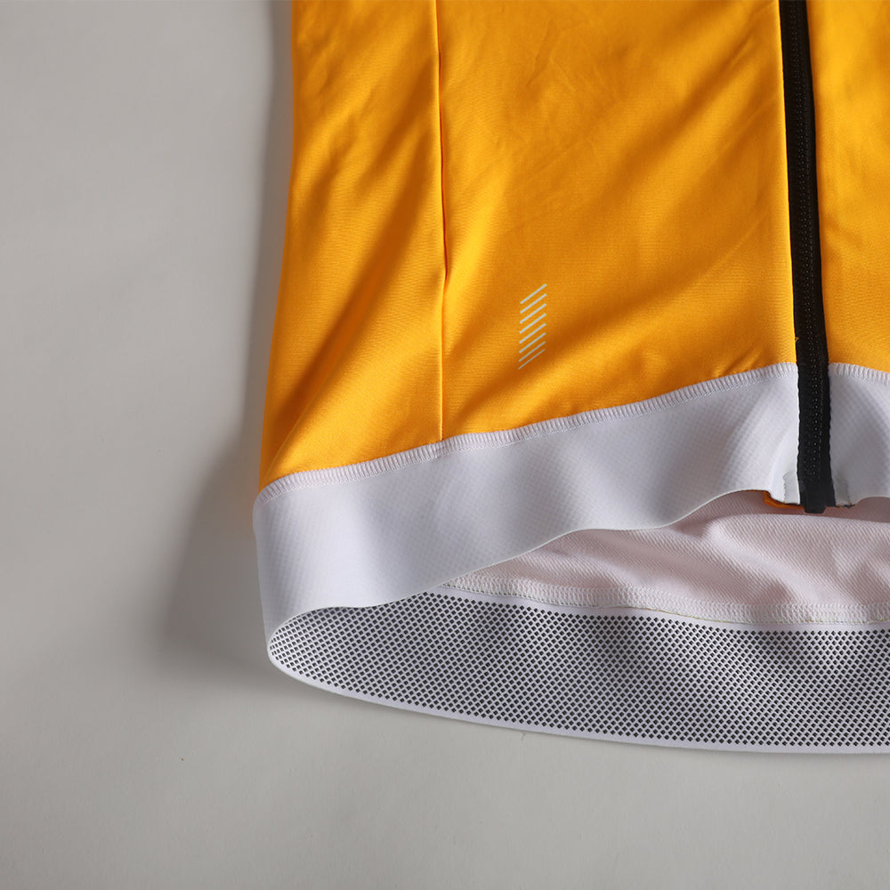 Close-up of women's Solarflare thermal jersey in yellow, with white trim & reflective details.