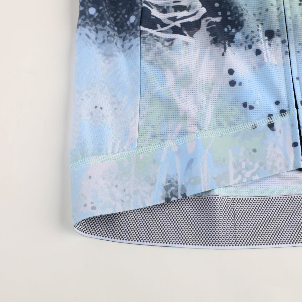 Close-up of C&C Overspray Jersey for men, featuring light blue, white, and dark blue abstract print.