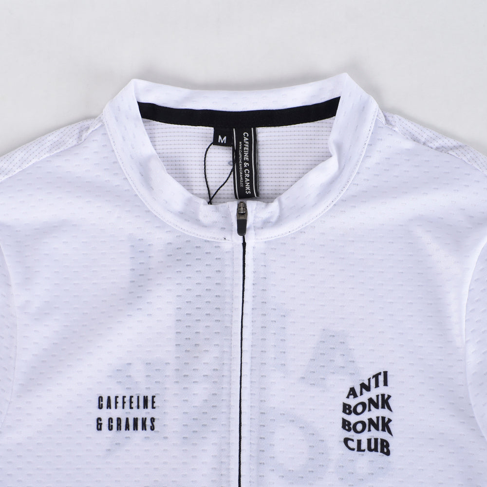 Closeup of C&C Bonk Club Mens Jersey. White with black logos and zipper detail.