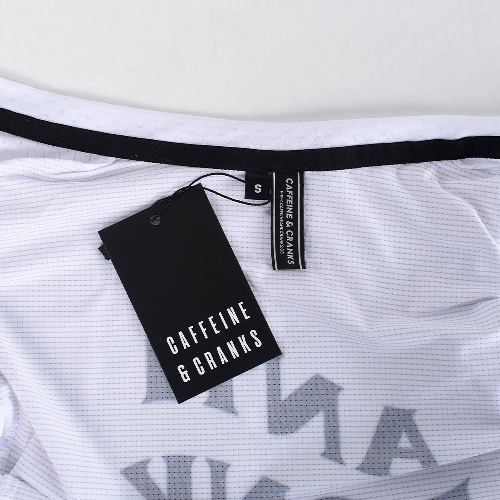 Close-up of a white C&C Bonk Club Jersey with black trim and tags.