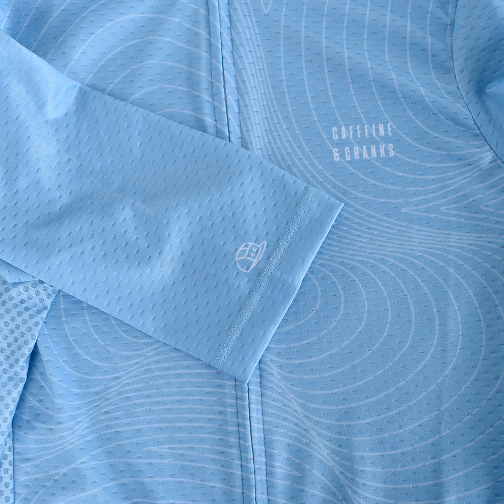 Close up of C&C Cerulean Topo Jersey (mens). Blue with white topographic pattern & logo.