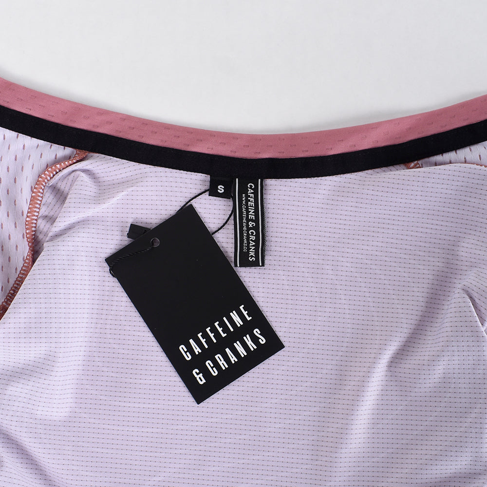 Close-up of C&C Garnet Topo Jersey interior, showing pink details, black tag, and size S.