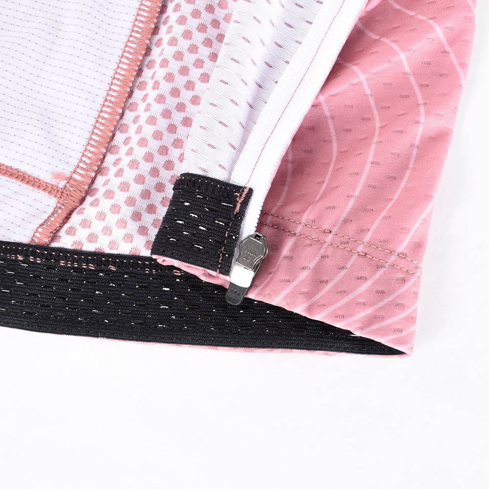 Close-up of C&C Garnet Topo Jersey, showing pink topo print, white panels, black hem w/ zipper.