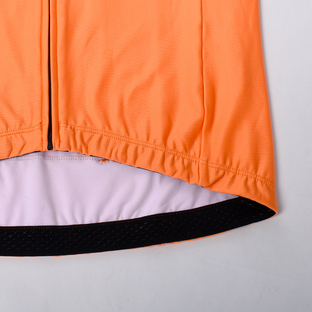 Close-up of an orange thermal jersey showing the hem and zipper.