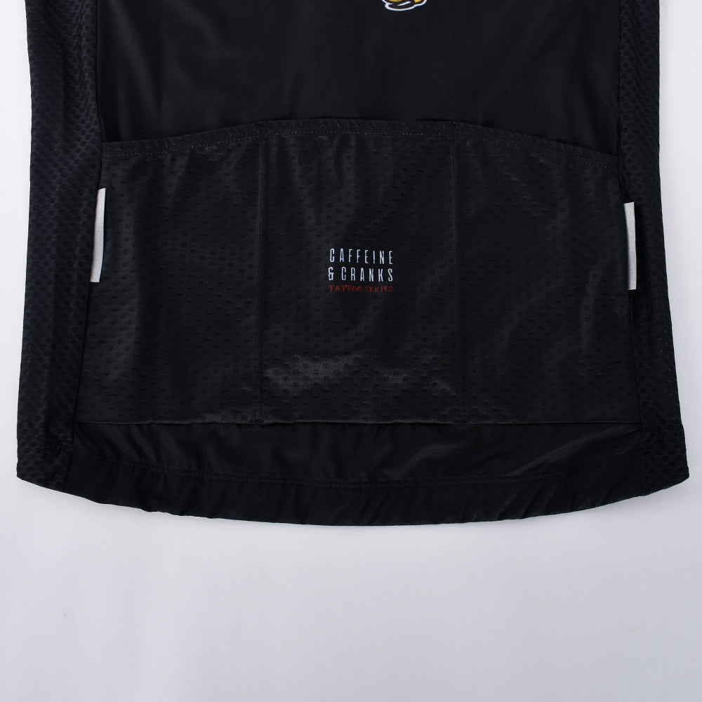 Back view of black C&C Tattoo Series men's jersey with triple pockets and reflective accents.