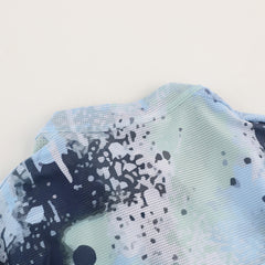 Close-up of C&C Overspray Jersey Women's collar and shoulder. Features a mesh fabric with blue, green, and white abstract spray paint print.