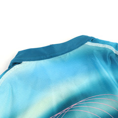 Close-up of C&C Flux Jersey neckline, women's, teal blue gradient, mesh fabric, pink accents.