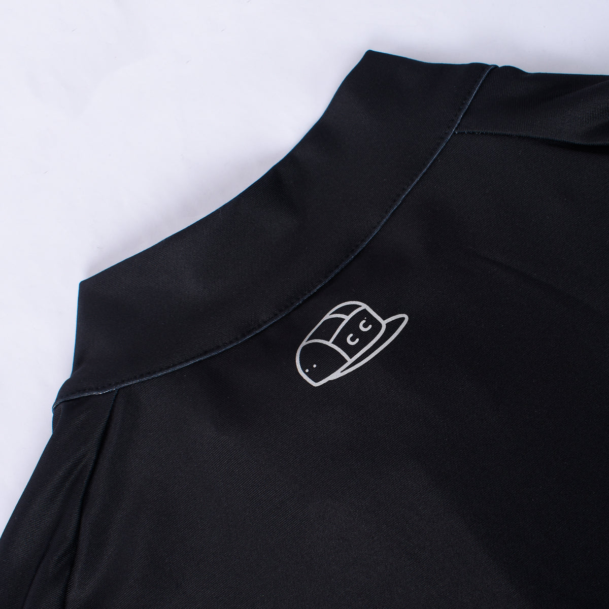Close-up of black mens Core Thermal Jersey showing neckline and white logo.