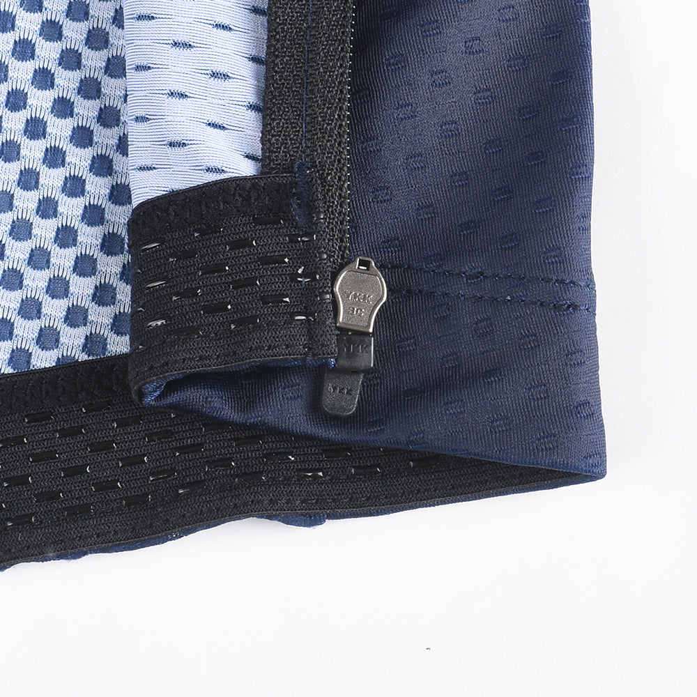 Close-up of C&C Pay Rego Jersey sleeve hem showing black YKK zipper & navy blue fabric with subtle dot pattern.