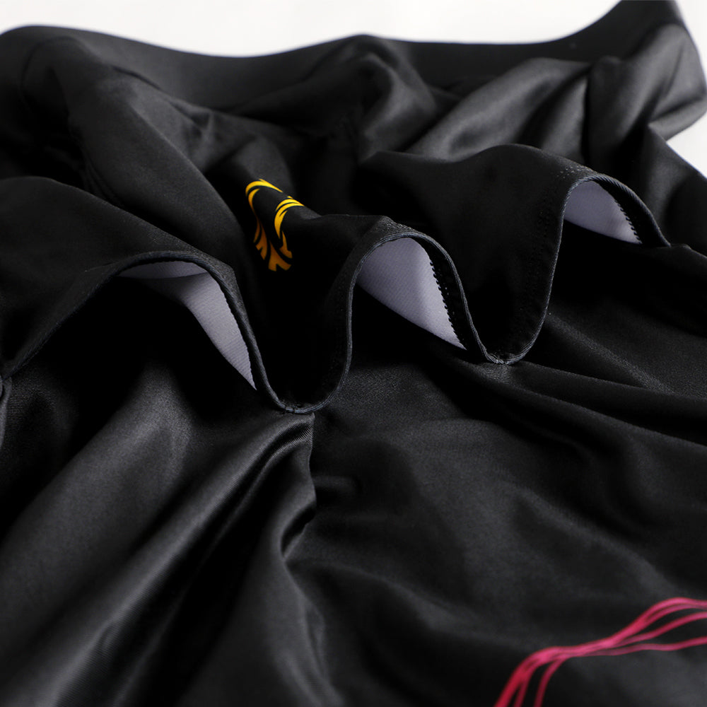 Close-up of a black men's thermal jersey with yellow logo and pink accents.