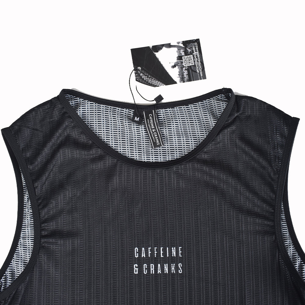 Close-up view of a black C&C Core Baselayer for women, featuring a mesh neck and white logo.