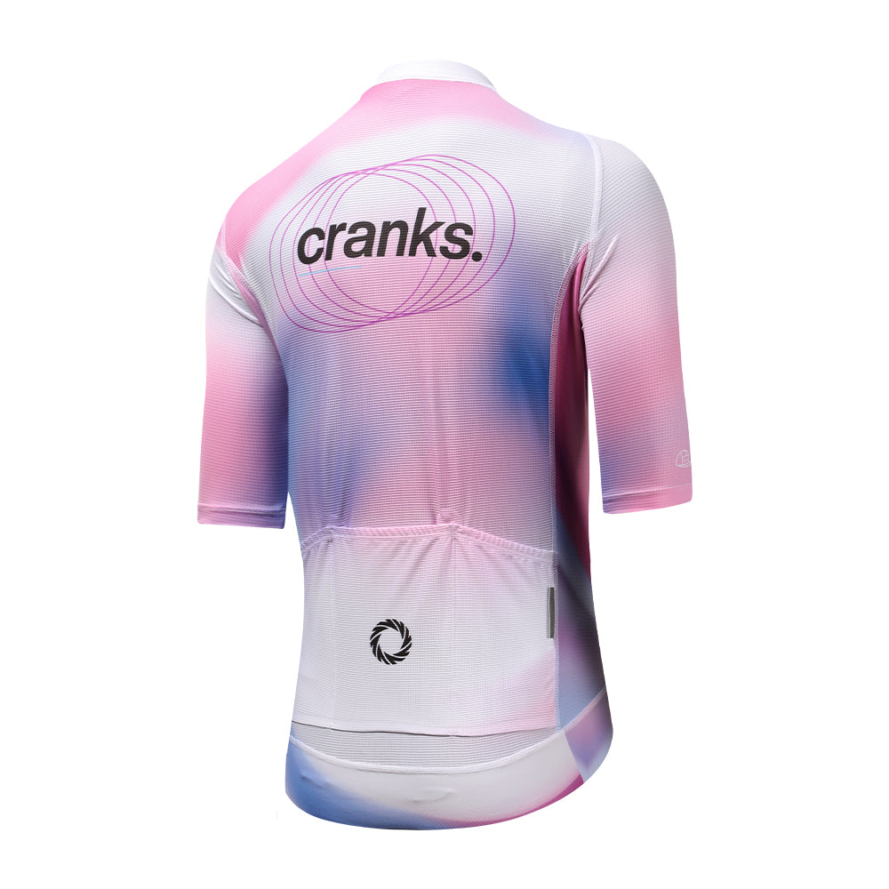 Back view of women's C&C Drift cycling jersey in pink, purple, and blue gradient with logo.