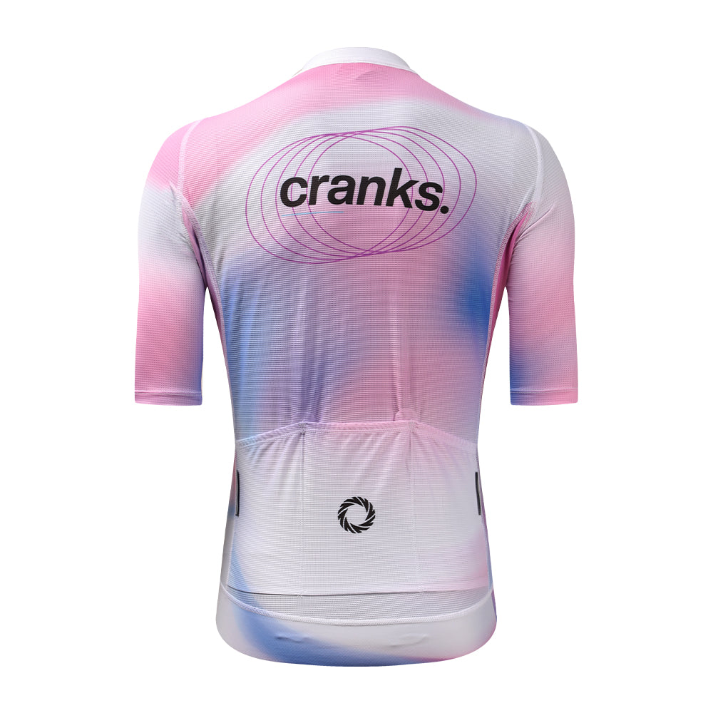 Back view of C&C Drift Jersey in pink, white & blue abstract print with "cranks." logo.