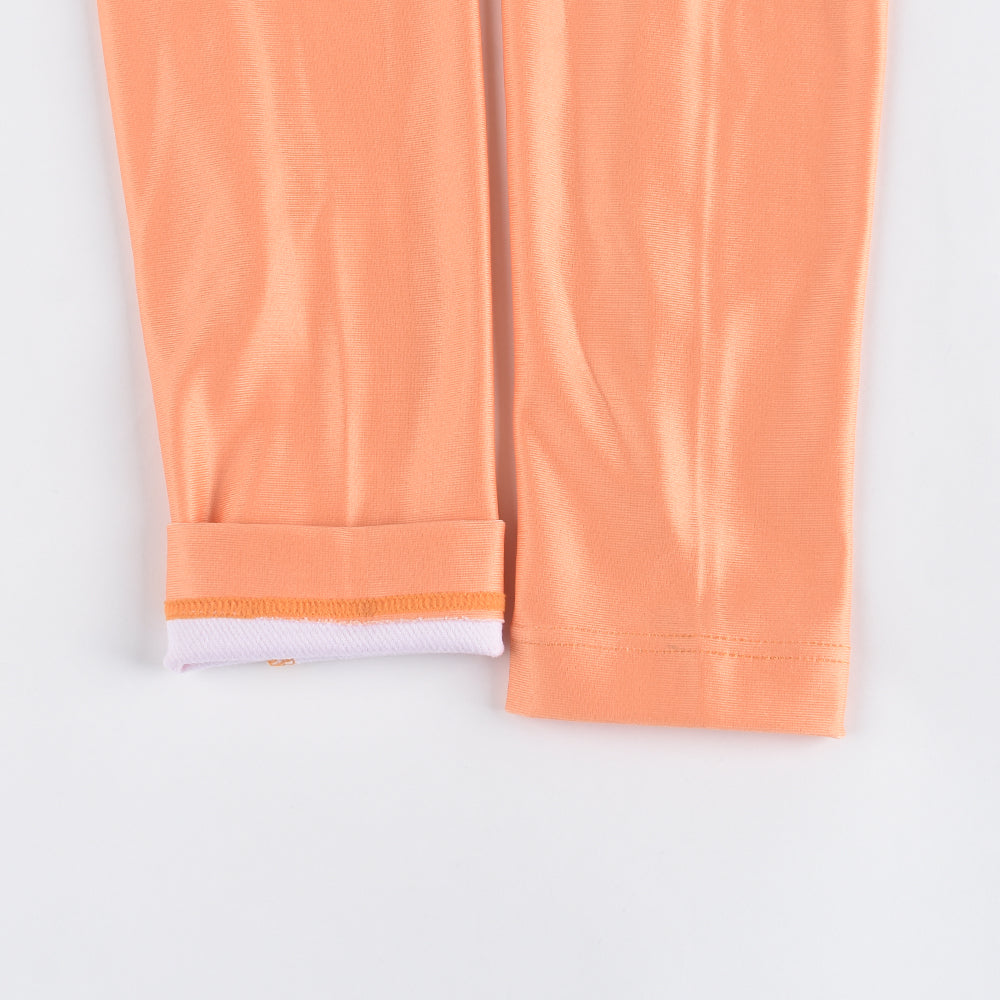 Close-up of orange thermal jersey sleeve cuff with white lining.