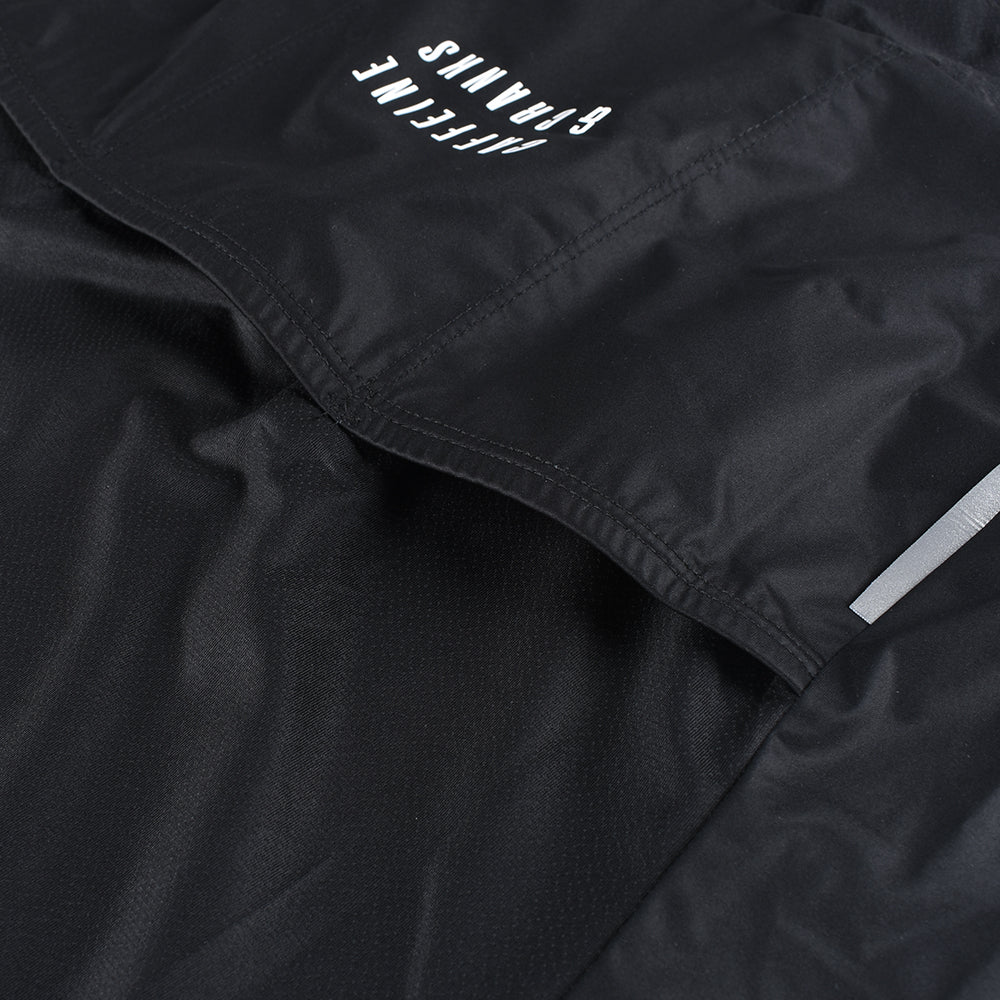 Close-up of black C&C Core Gilet for men, showing pocket detail and reflective strip.