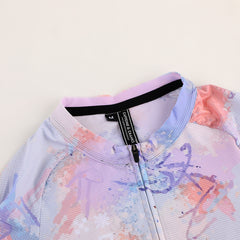 Close-up of a C&C Vapour Jersey in white with a watercolor splash print in pink, purple, and blue.