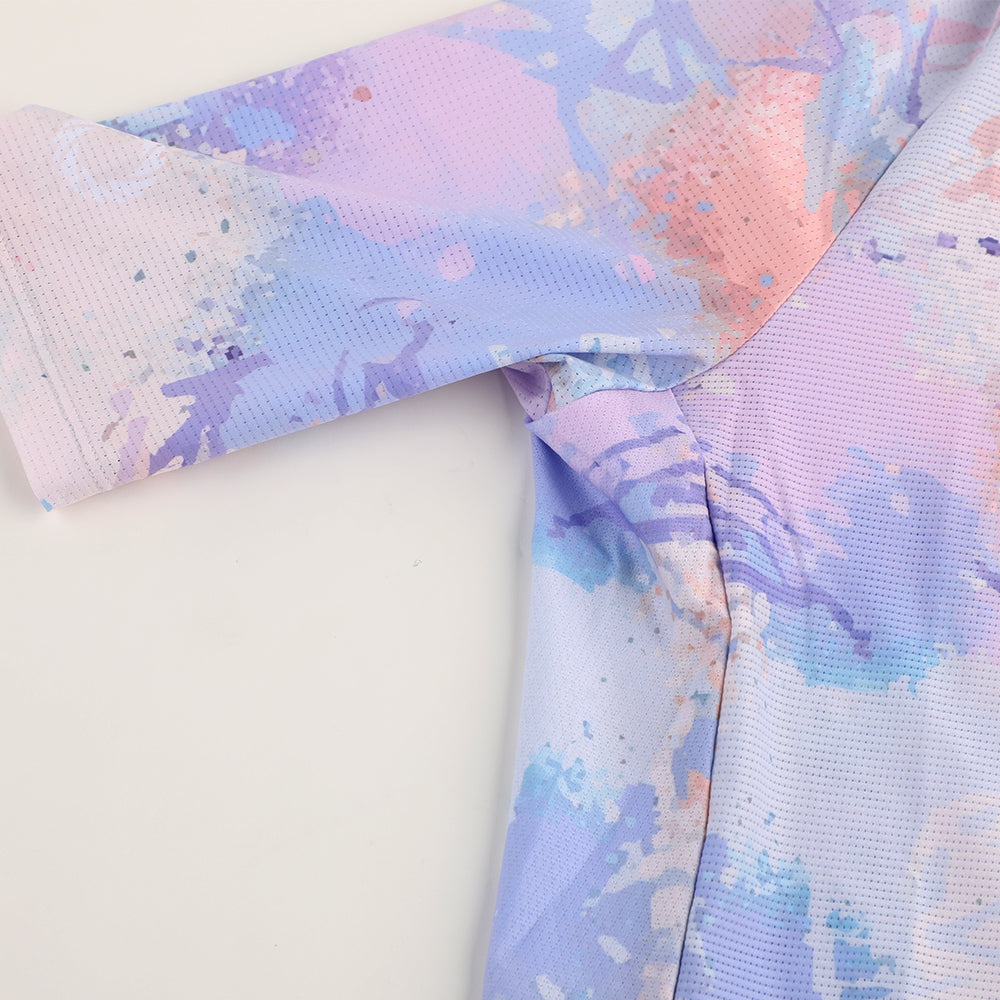 Close-up of C&C Vapour Jersey sleeve. Features a purple, pink, and blue paint splatter print and breathable mesh fabric.