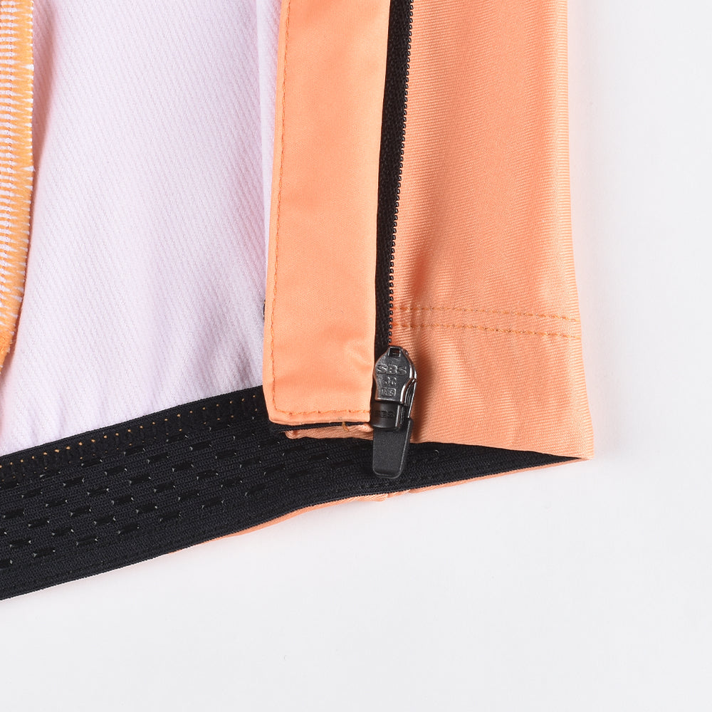 Close-up of women's orange thermal jersey. Features orange fabric, black zipper, and gripper band.