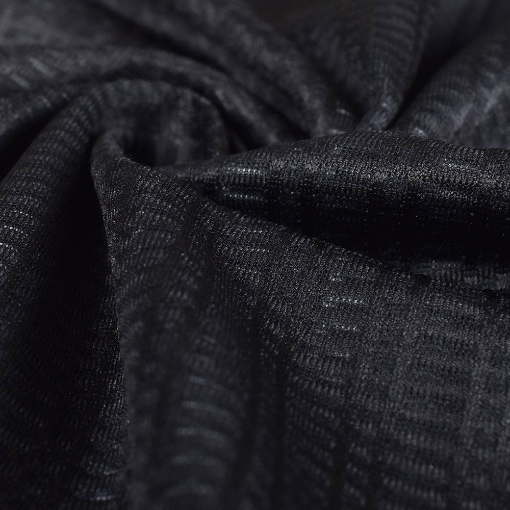 Close-up view of black C&C Core Baselayer fabric with a textured weave.