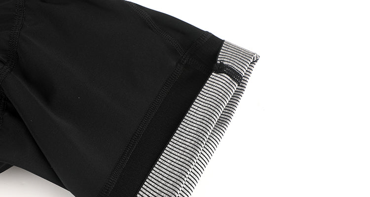 Close-up of black men's cargo bib shorts with a striped grey cuff.