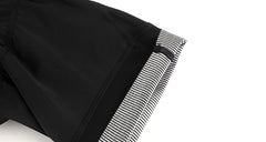 Close-up of black men's cargo bib shorts with a striped grey cuff.