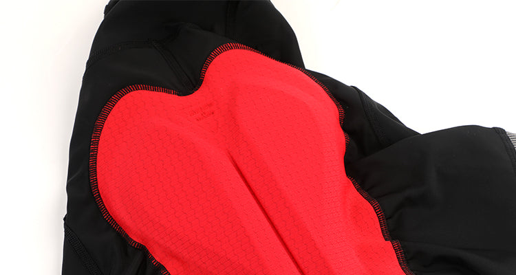 Close up of black Stealth bib shorts with a textured red chamois padding.