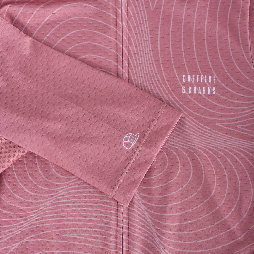 Close-up of men's C&C Garnet Topo Jersey sleeve and torso in pink with white topo pattern.