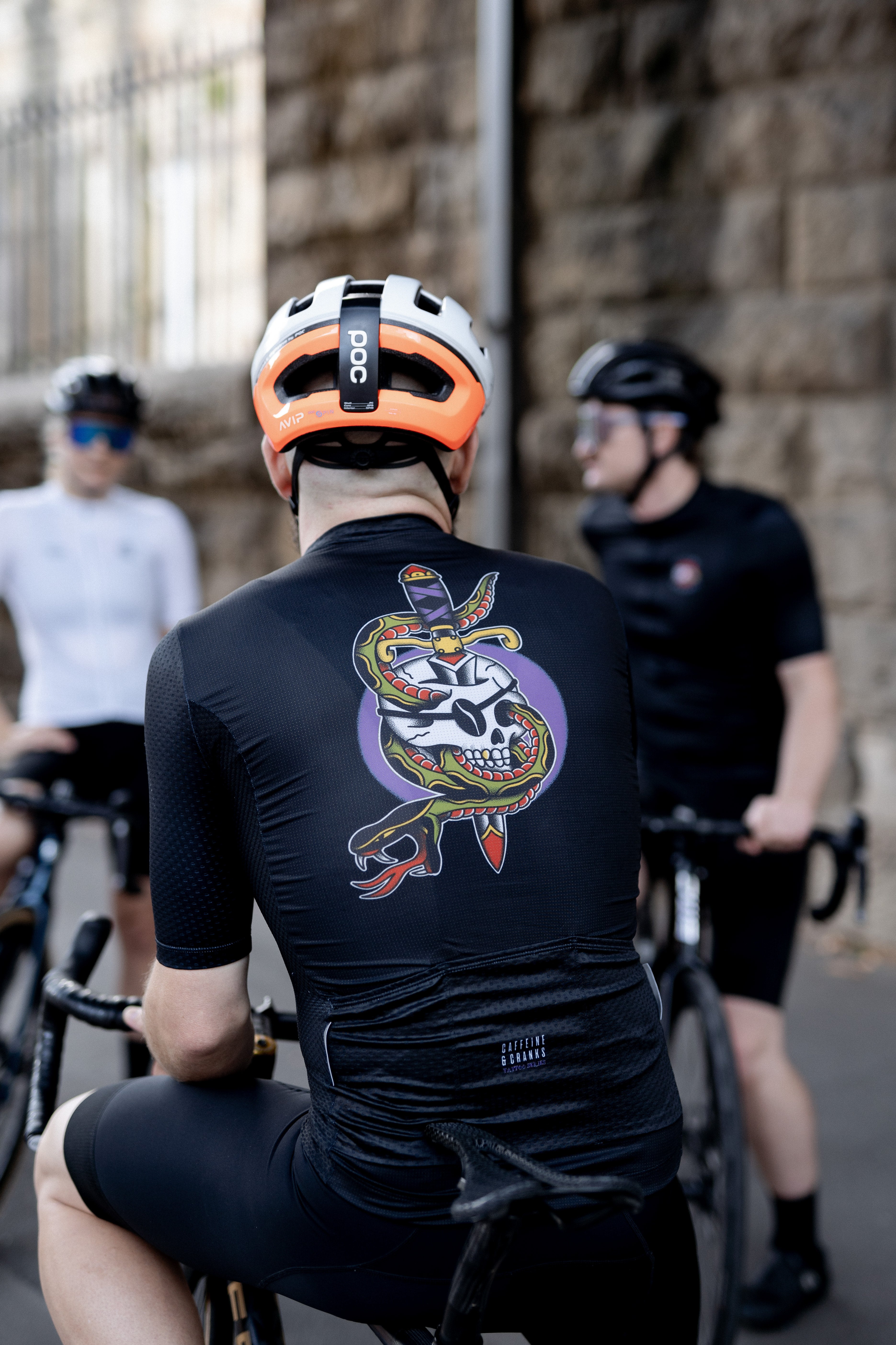 Back view of men's black C&C Tattoo jersey with skull & snake graphic.
