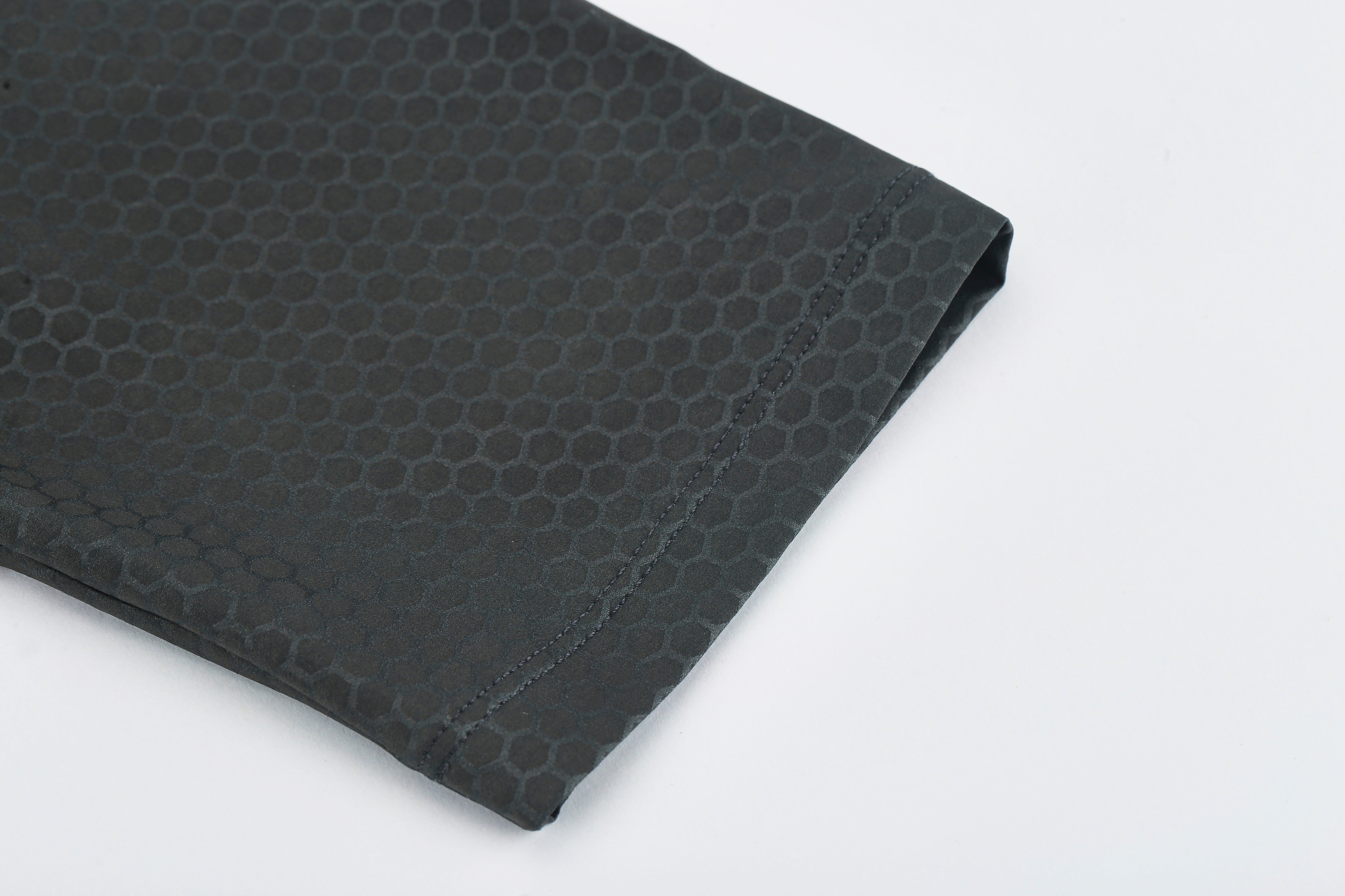 Close up of men's slate grey Pinnacle Jersey sleeve with honeycomb texture.