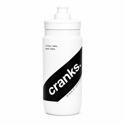 A white plastic water bottle with a matching white flip-top lid, featuring a bold black diagonal graphic on the front with the brand name 'cranks.' in white lowercase letters.